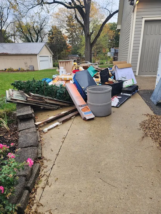 Dumpster being loaded with debris for 10 Yard Dumpster Rental in St. Joseph